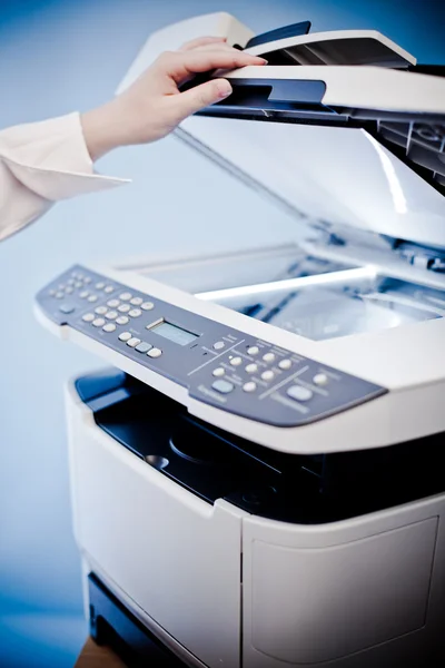 Woman's hand with working copier — Stock Photo, Image