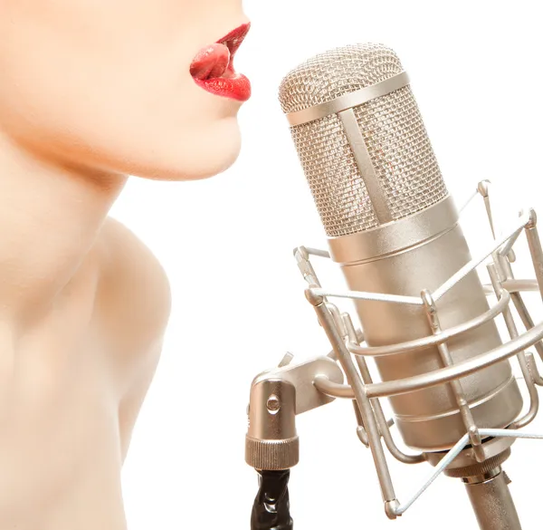 Woman in foil mask with studio microphone — Stock Photo, Image