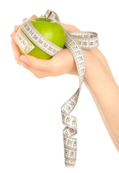 Woman's hands holding ripe green apple with measuring tape — Stock Photo, Image