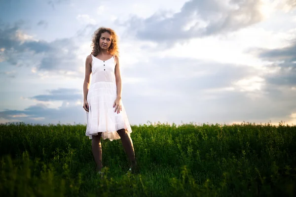 Mujer de pie sobre la naturaleza y sonriendo — Foto de Stock