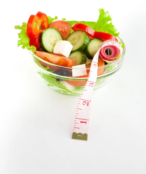 Picture of a plate with greek salad and tape- measure — Stock Photo, Image