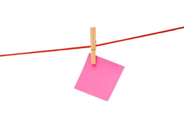 Pink sticky hanged on red rope — Stock Photo, Image