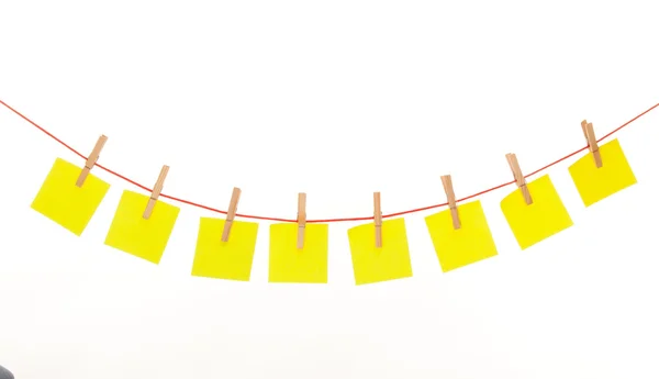 Yellow stickies hanged on red rope — Stock Photo, Image