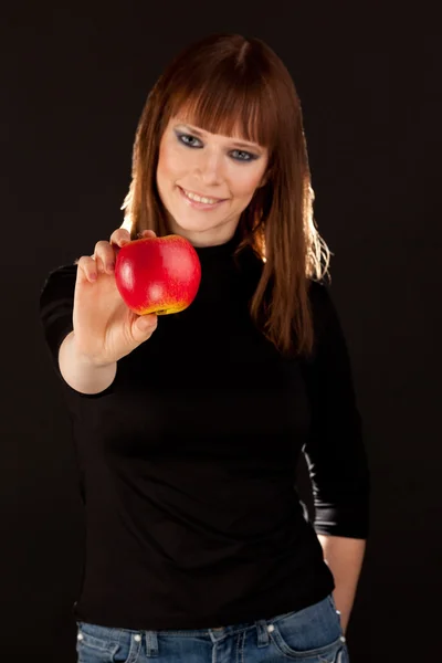 Beautiful woman with red apple (focus on apple) — Stock Photo, Image