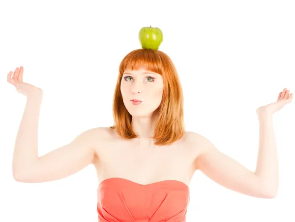 Beautiful woman with green apple on her head — Stock Photo, Image