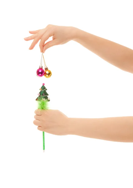 Woman's hands with new year balls isolated on white — Stock Photo, Image