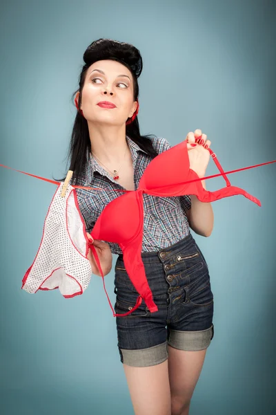 Beautiful woman hanging her panties and bra — Stock Photo, Image