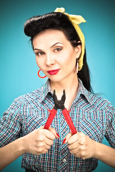 Girl in check shirt with pliers — Stock Photo, Image