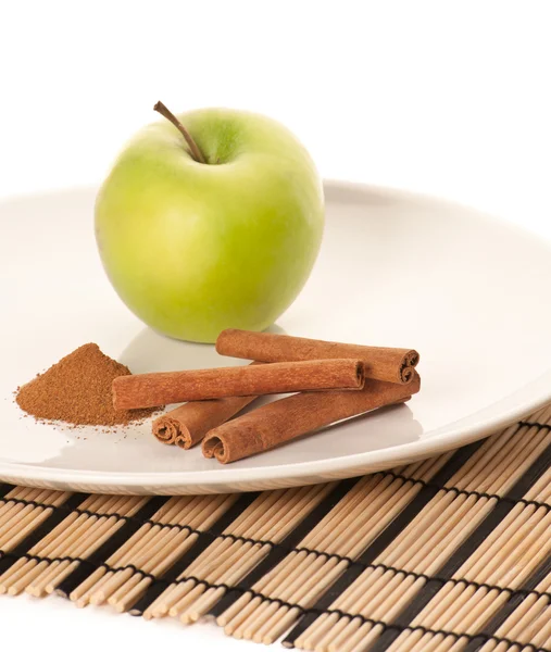 Picture of green apple and spices on the white plate (focus on c — Stock Photo, Image