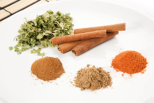 Plate with different spices on the table — Stock Photo, Image