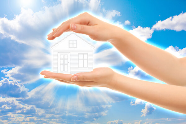 Picture of woman's hands holding a house