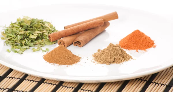 Plate with different spices on the table — Stock Photo, Image