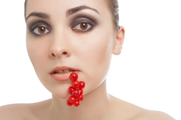 Woman with red currant in her lips — Stock Photo, Image