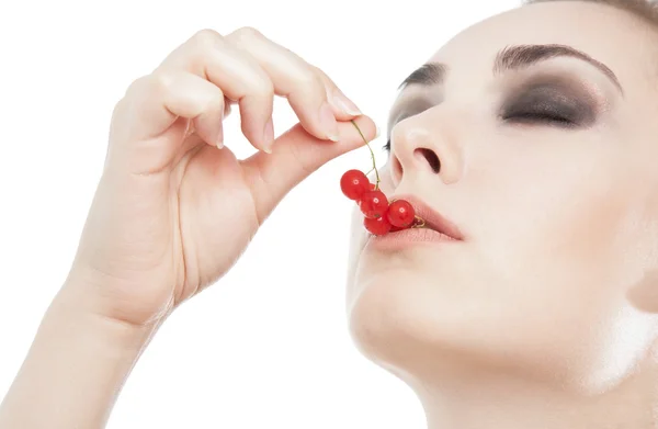 Sexy woman with red currant  in her lips — Stock Photo, Image