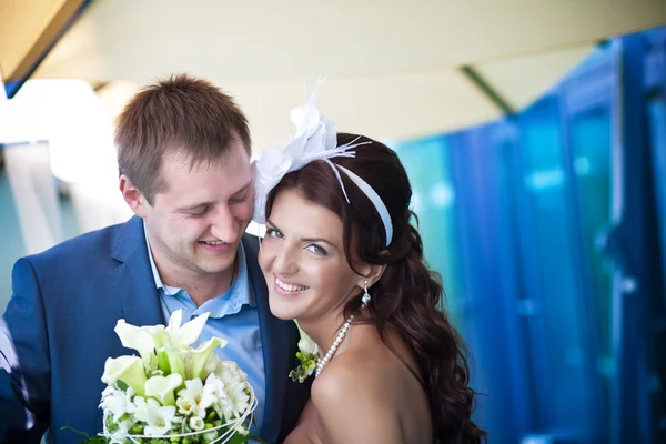 Bride and groom is laughing near the glass — Stock Photo, Image