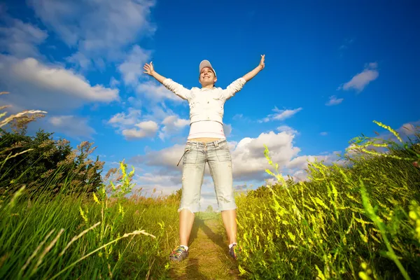 Happy girl is jumping over the blue sky — Stock Photo, Image