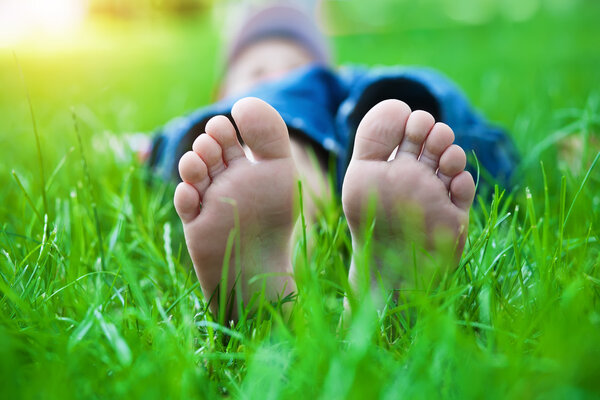 Feet on grass. Family picnic in spring park