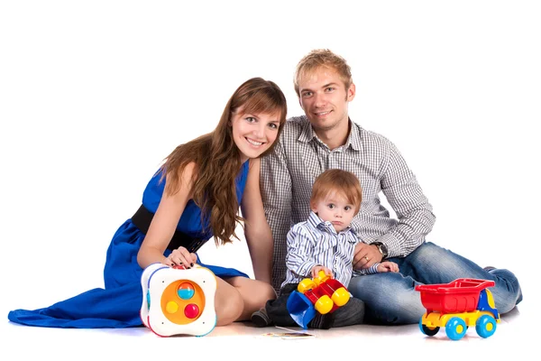 Happy parents with a baby in a studio. isolated — Stock Photo, Image