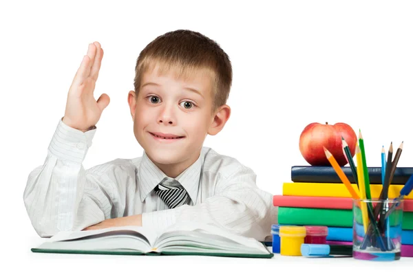 Cute schoolboy is pulling his hand to answer — Stock Photo, Image