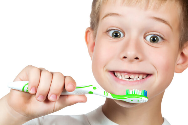 Cheerful boy is brushing his teeth isolated