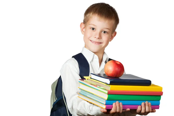 Милый мальчик держит книги и яблоко. изолированные — стоковое фото