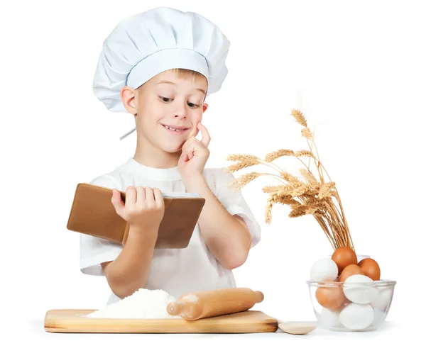 Chef boy is reading a recipe cook — Stock Photo, Image