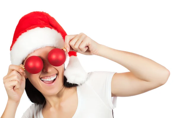 Menina bonito em um chapéu de Papai Noel com bolas de Natal — Fotografia de Stock