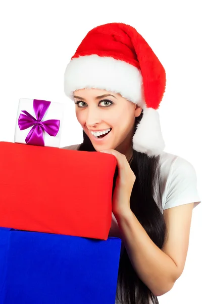 Happy woman in a Santa Claus hat with lots of gifts — Stock Photo, Image