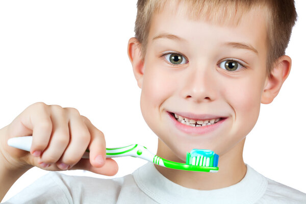 Cheerful boy is brushing his teeth