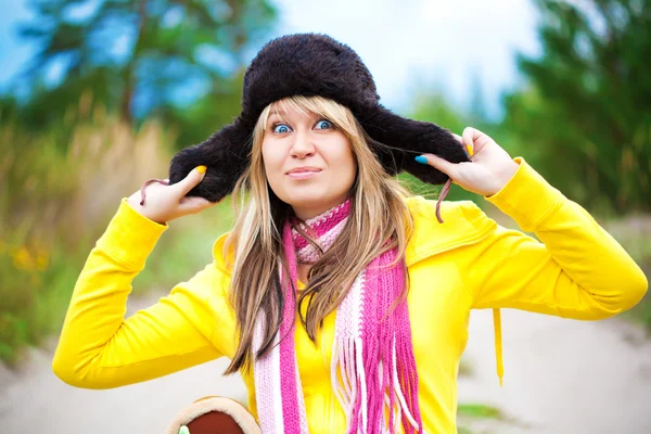 Funny girl in cap with ear flaps — Stock Photo, Image