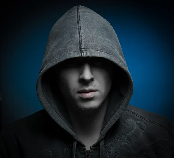 Scary zombie man with hood in darkness — Stock Photo, Image