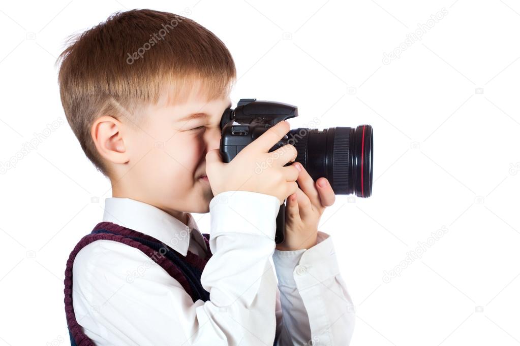 Boy is holding camera and taking a photo