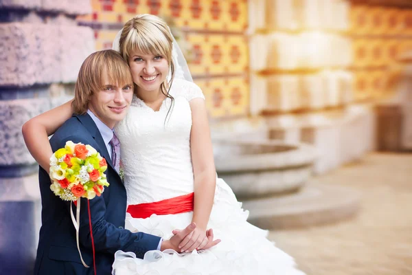 Happy couple near the patterned wall — Stock Photo, Image