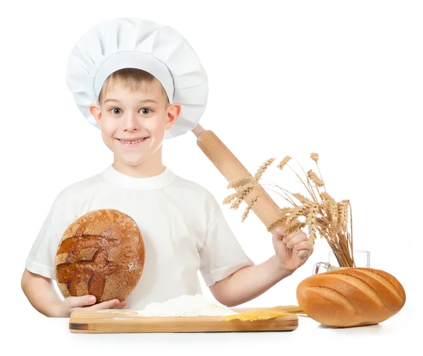 Funny little baker is kneading dough — Stock Photo, Image