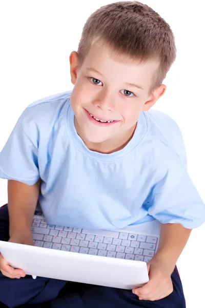 Schattige jongen met laptop op wit. bovenaanzicht — Stockfoto