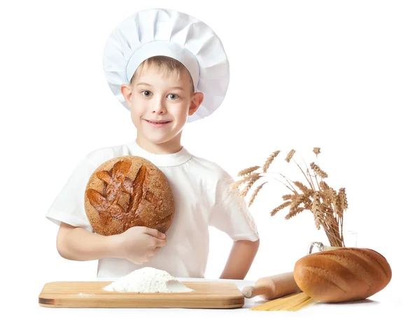 Cute baker boy with a loaf of rye bread — Stock Photo, Image