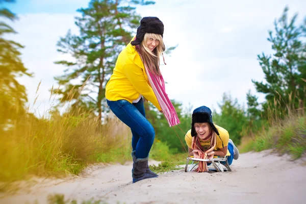 Crazy boy and girl are sledding at summer — Stock Photo, Image
