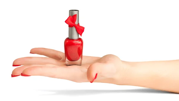 Ženská ruka s lahví červený lak na nehty — Stock fotografie