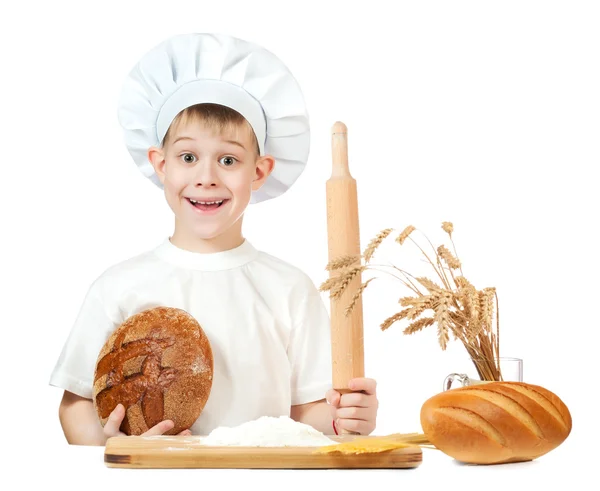 Little baker boy with a loaf of rye bread and rolling pin — Stock Photo, Image