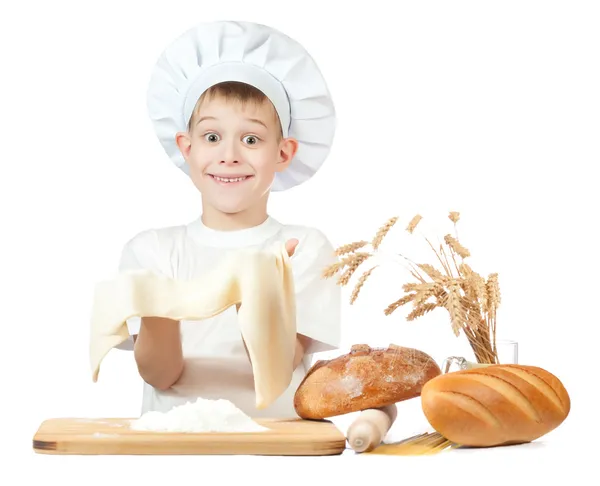 Little baker is kneading dough — Stock Photo, Image