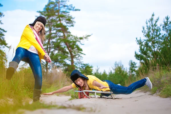 Crazy boy and girl are sledding at summer — Stock Photo, Image