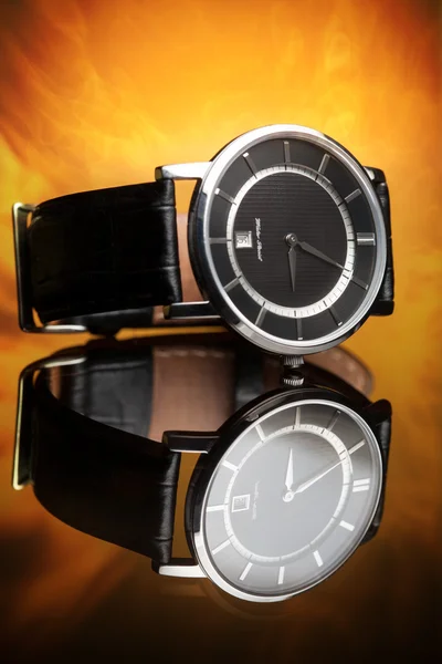 Watches with leather strap on a flame background — Stock Photo, Image