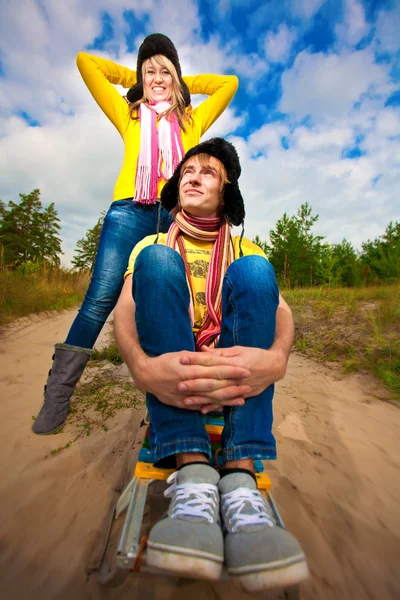 Funny couple are sledding at summer — Stock Photo, Image