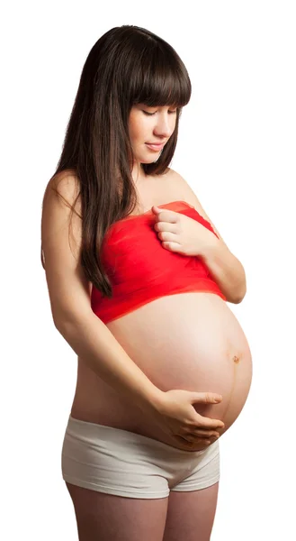 Femme enceinte en rouge isolé — Photo