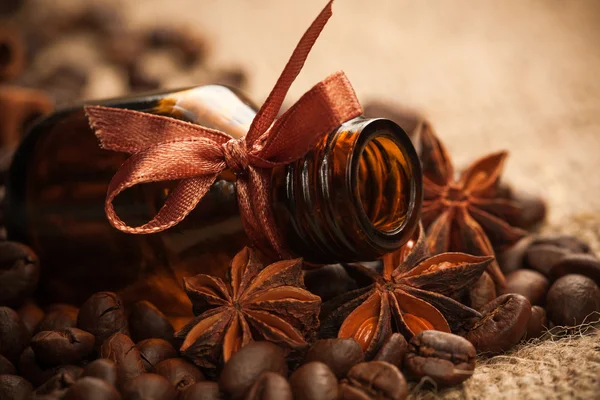 Bottle fragrant oil with aromatic coffee beans — Stock Photo, Image