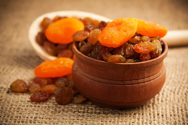 Dried fruit on a wooden spoon on a burlap — Stock Photo, Image