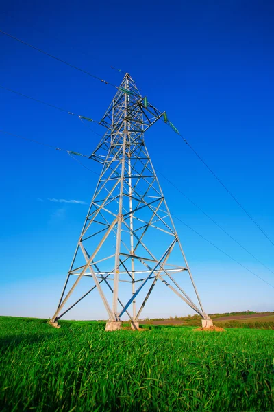 Power lines steel construction against blue sky — Stock Photo, Image