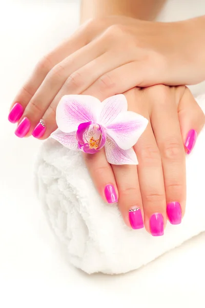 Pink manicure with pink orchid and towel — Stock Photo, Image