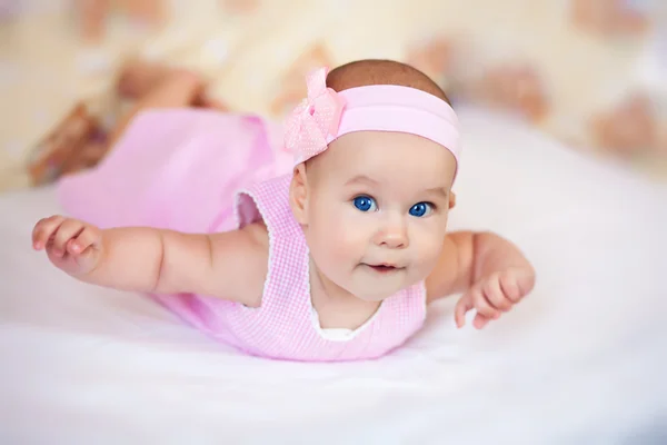 Funny baby girl in a pink dress — Stock Photo, Image