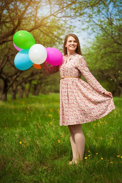 Happy girl is playing on the green spring meadow — Stock Photo, Image